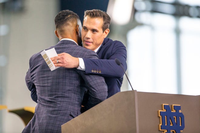 Former Notre Dame quarterback Brady Quinn hugs Marcus Freeman during a press conference introducing Freeman as the new Notre Dame head football coach on Monday, Dec. 6, 2021, at the Irish Athletics Center in South Bend.