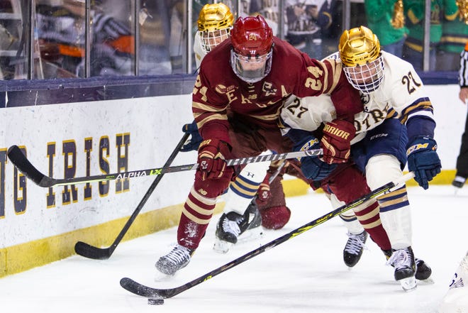 Notre Dame's Trevor Janicke (27) tries to get past Boston College's Patrick Giles (24) during the Notre Dame vs. Boston College NCAA men's hockey game Wednesday, Jan. 19, 2022 at the Compton Family Ice Arena in South Bend.